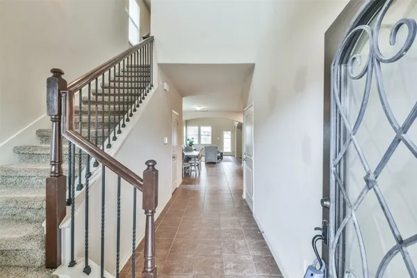 a view of a hallway with wooden floor and stairs