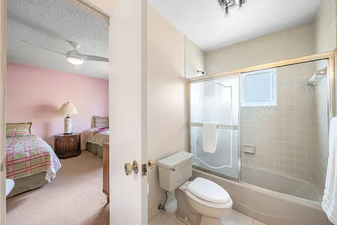 a bathroom with a toilet a sink and a shower