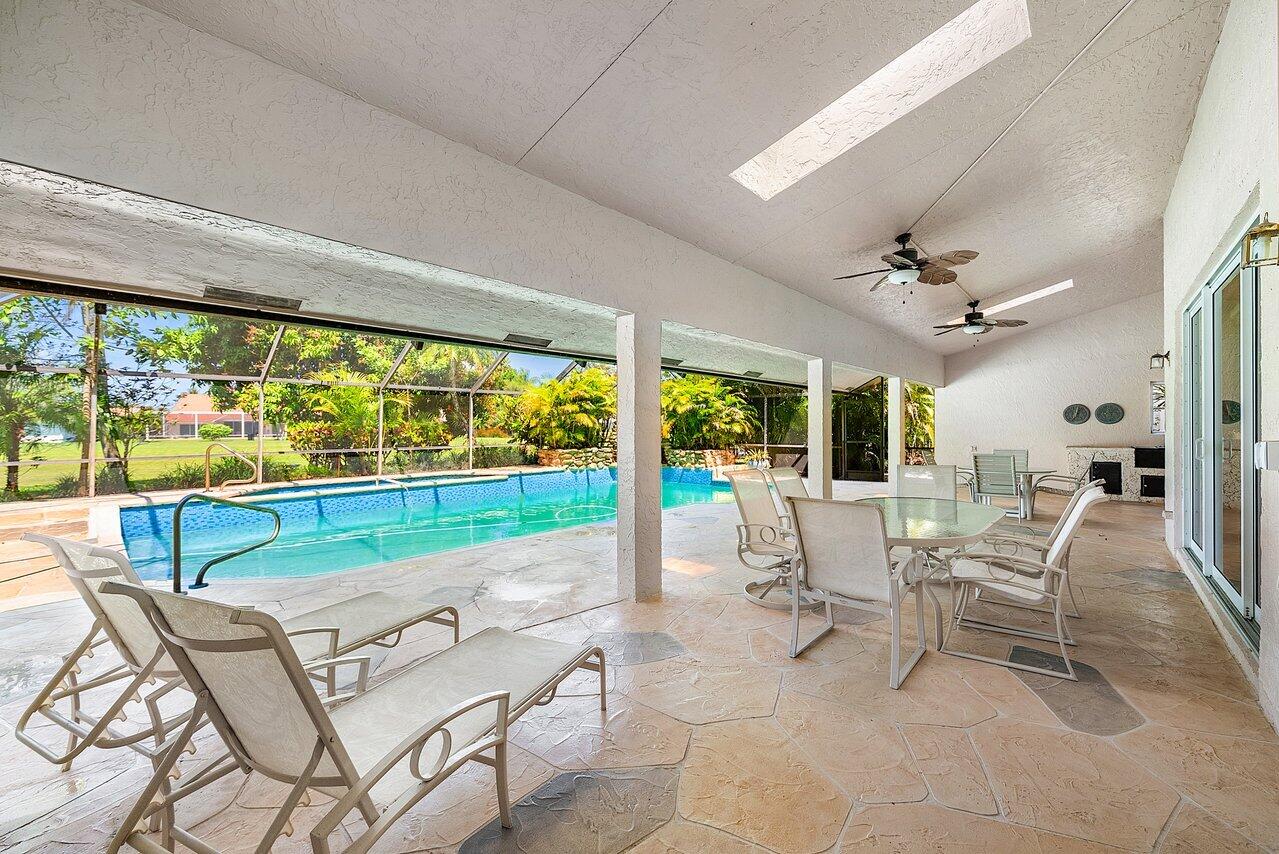 10215 Boca Woods Lane Boca Raton, FL 33428 - Photo 15 of 22 a dining room with furniture and large windows
