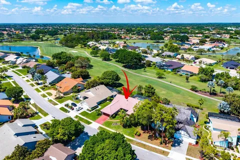 an aerial view of residential houses with outdoor space and street view