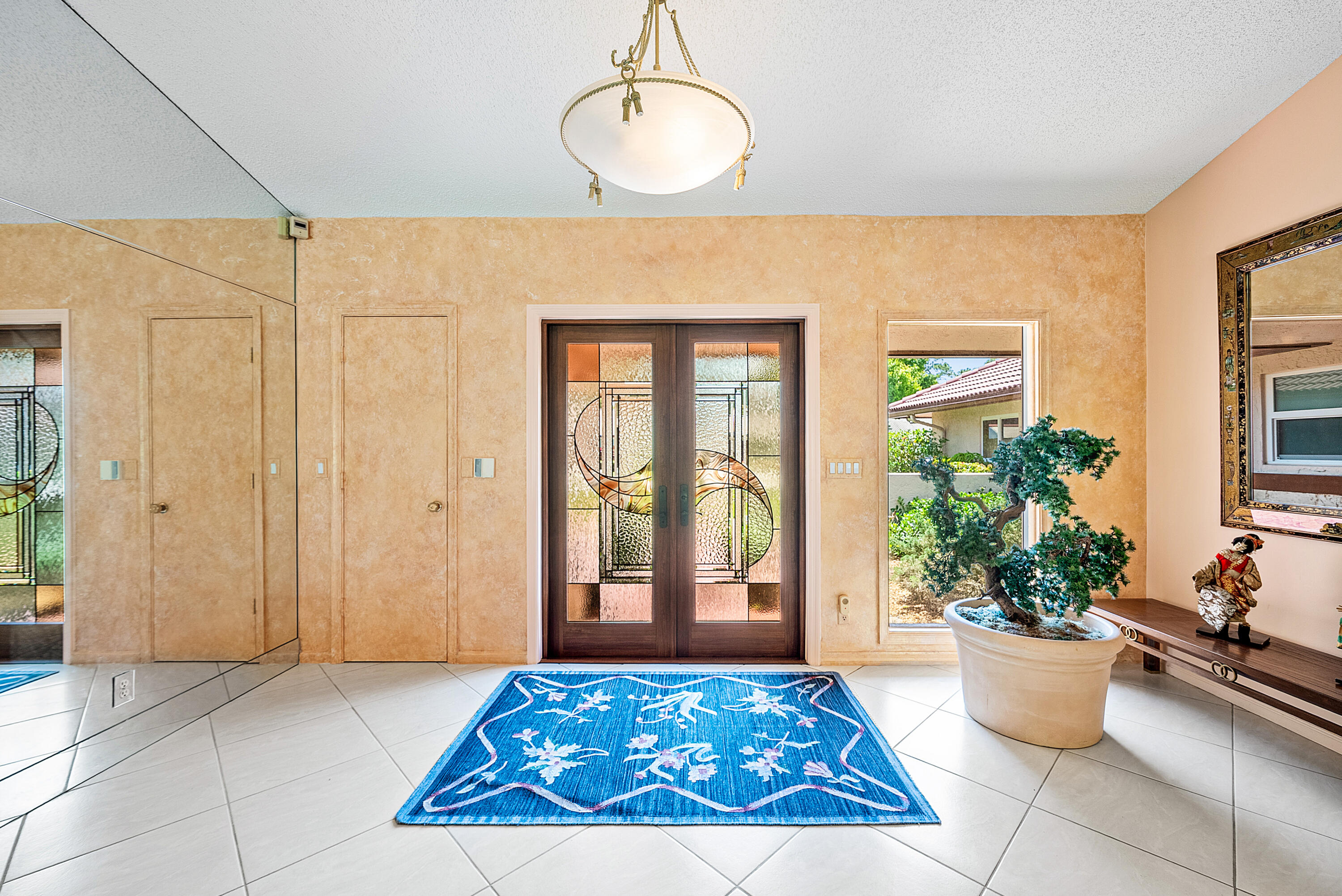 10215 Boca Woods Lane Boca Raton, FL 33428 - Photo 2 of 22 a living room with a couch and potted plant