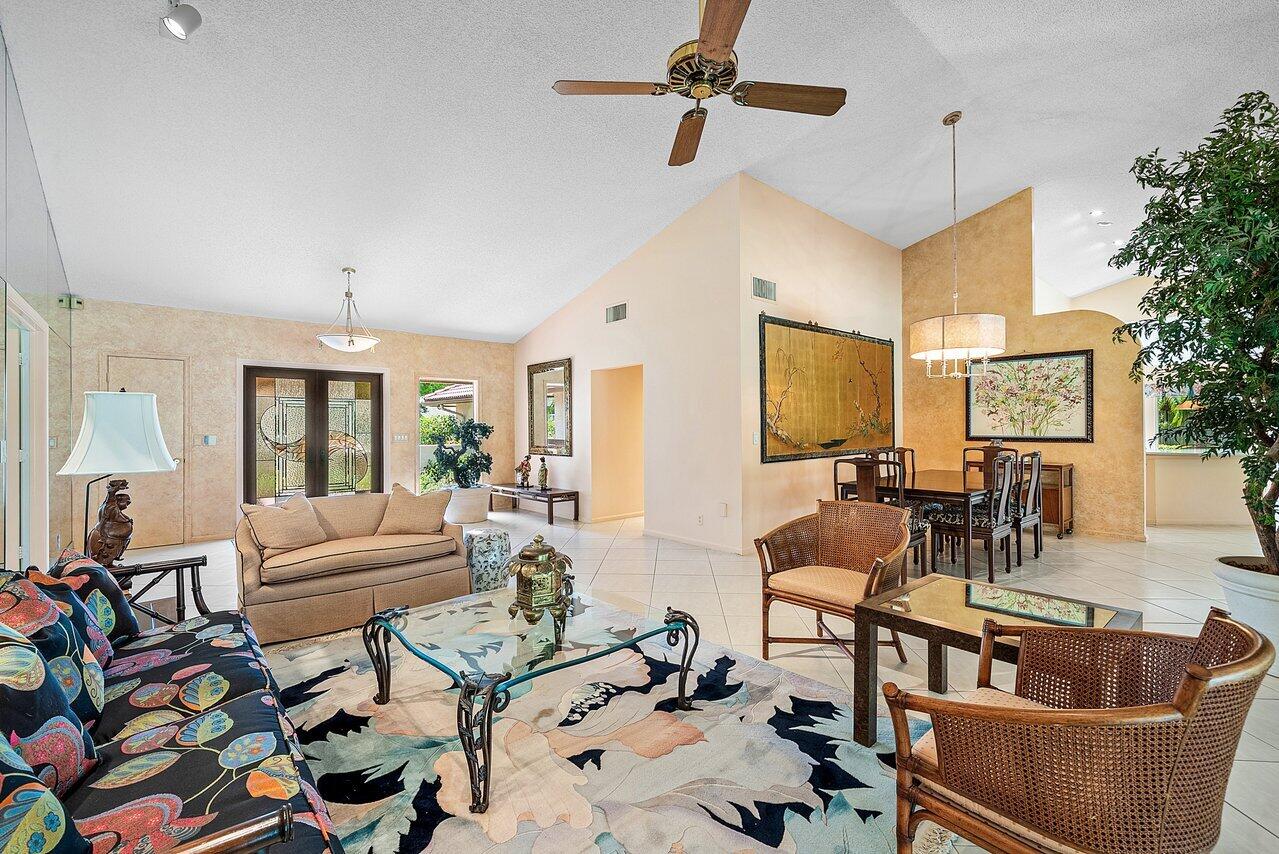 10215 Boca Woods Lane Boca Raton, FL 33428 - Photo 3 of 22 a living room with furniture and a flat screen tv