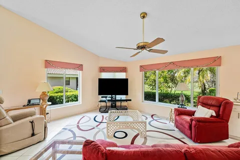 a living room with furniture a window and a flat screen tv