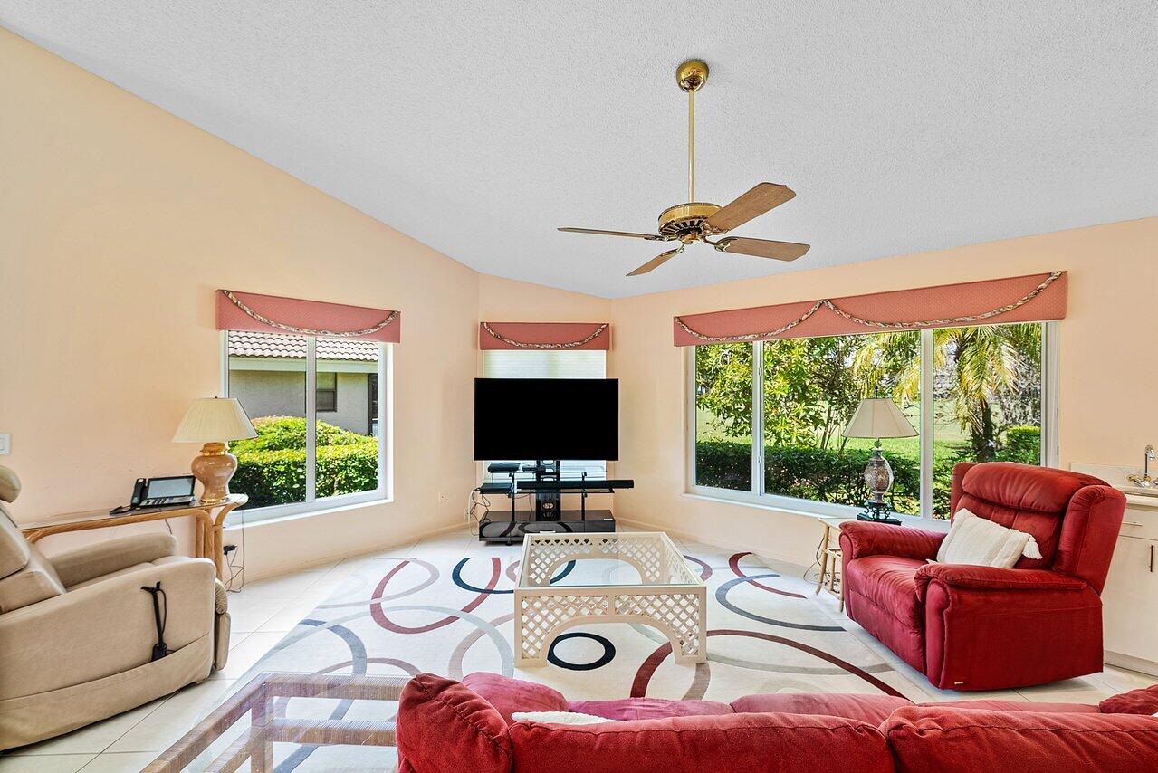 10215 Boca Woods Lane Boca Raton, FL 33428 - Photo 8 of 22 a living room with furniture a window and a flat screen tv