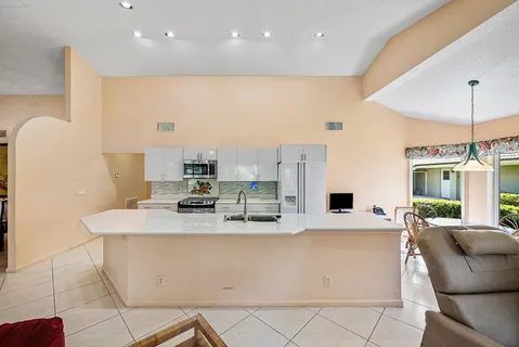 a view of kitchen with stainless steel appliances kitchen island
