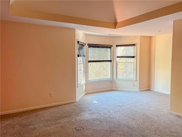 an empty room with windows and closet