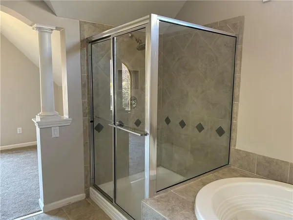 a bathroom that has a glass shower door
