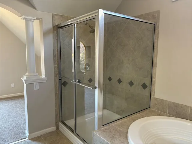 a bathroom that has a glass shower door