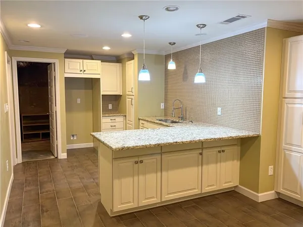 a bathroom with a granite countertop sink a mirror and a shower