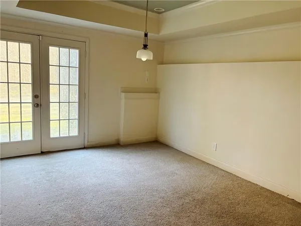 an empty room with a windows and ceiling fan