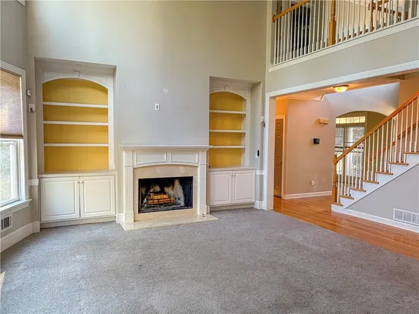 a view of a livingroom with a fireplace and window