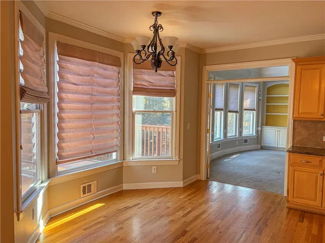 a view of an entryway with wooden floor and door