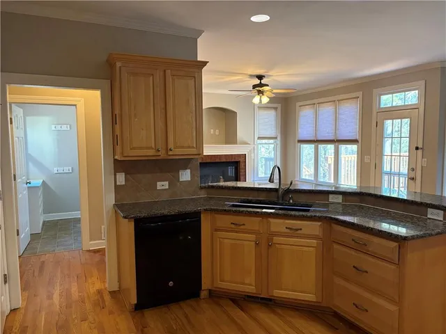a kitchen with granite countertop a stove and a sink