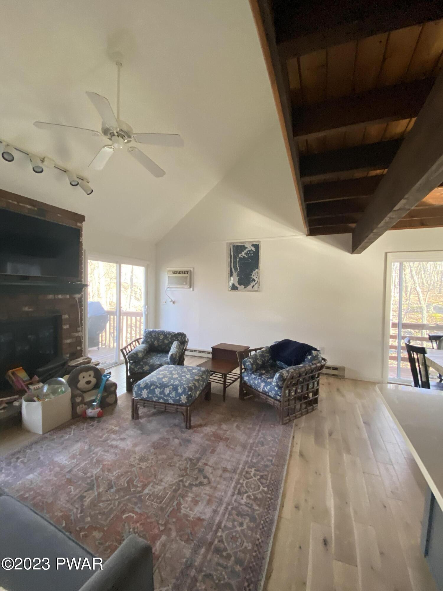 101 Maple Ridge Drive Hawley, PA 18428 - Photo 37 of 61 a living room with furniture gym equipment and a fireplace
