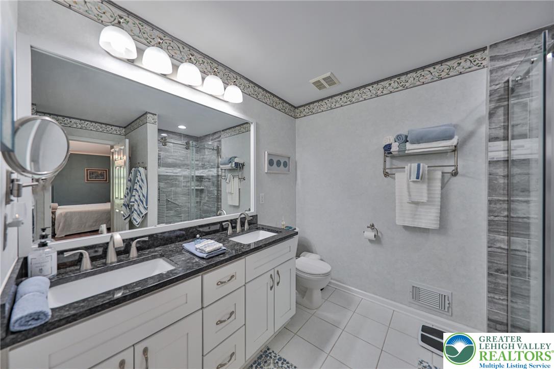 163 Muirfield Way Easton, PA 18042 - Photo 25 of 48 a bathroom with a double vanity sink a mirror and a toilet