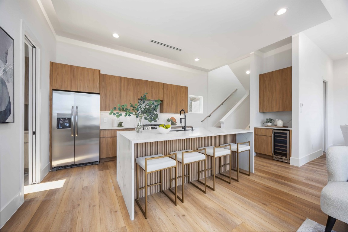 324 Janisch Road Houston, TX 77018 - Photo 1 of 18 a kitchen with stainless steel appliances a dining table chairs and wooden floor