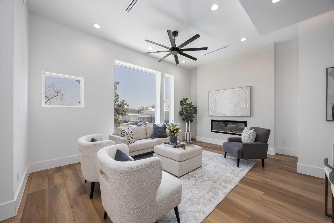 324 Janisch Road Houston, TX 77018 - Photo 5 of 18 Living room featuring a beautiful subtle plaster accent wall with a modern electric fireplace.