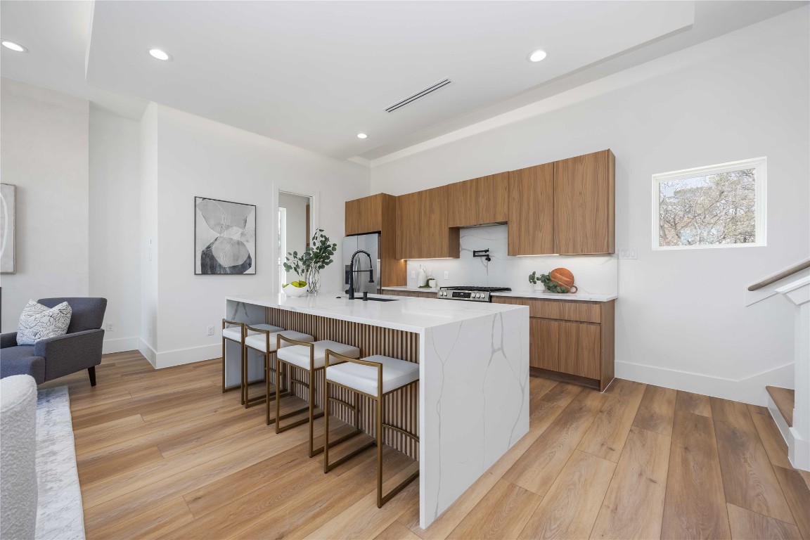 324 Janisch Road Houston, TX 77018 - Photo 6 of 18 Kitchen includes walk-in pantry featuring built-in appliances including a microwave and oven, along with ample shelving for organization.