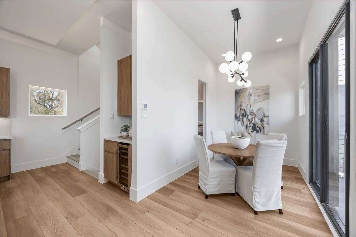 324 Janisch Road Houston, TX 77018 - Photo 7 of 18 a dining room with chandelier and wooden floor