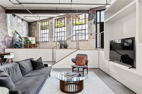 a kitchen with a table chairs and a wooden floor