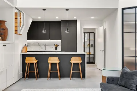 a room with pool table and windows