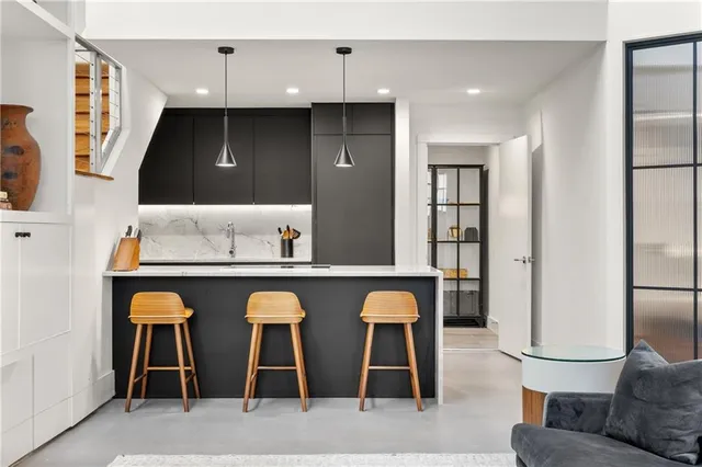 a room with pool table and windows