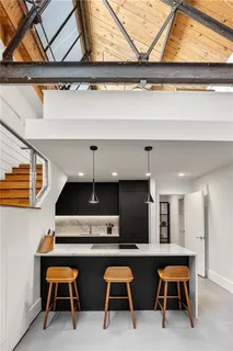 a kitchen with stainless steel appliances a sink stove and cabinets