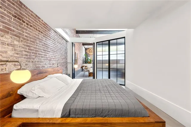 a view of a hallway with furniture and window