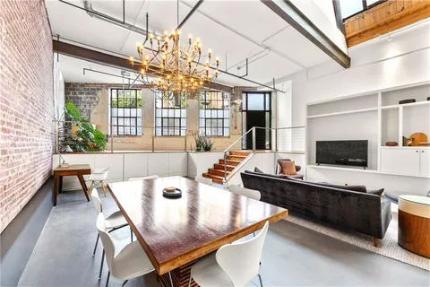 a living room with furniture a flat screen tv and a large window