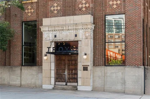a view of a brick house with a large windows