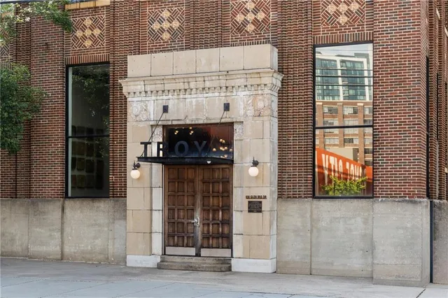 a view of a brick house with a large windows