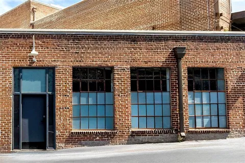 a view of a living room with a balcony and furniture