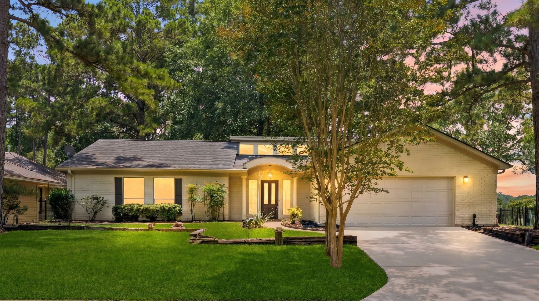 22509 Pebble Beach Way Point Blank, TX 77364 - Photo 2 of 30 Twilight view of the brick elevation along a quiet, tree-lined street