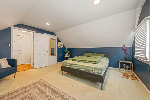 a bedroom with a bed and a night stand