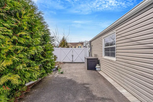 a backyard of a house with table and chairs
