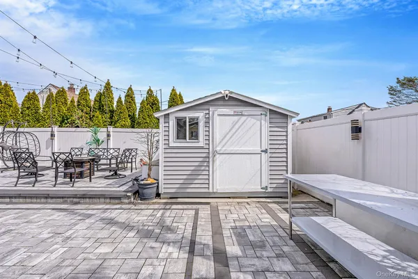 a view of a backyard with sitting area