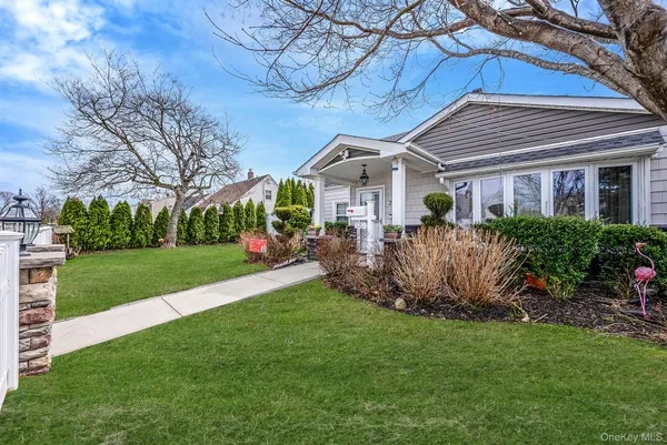 a front view of a house with a garden