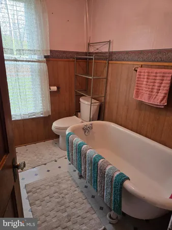 a bedroom with bed and a window