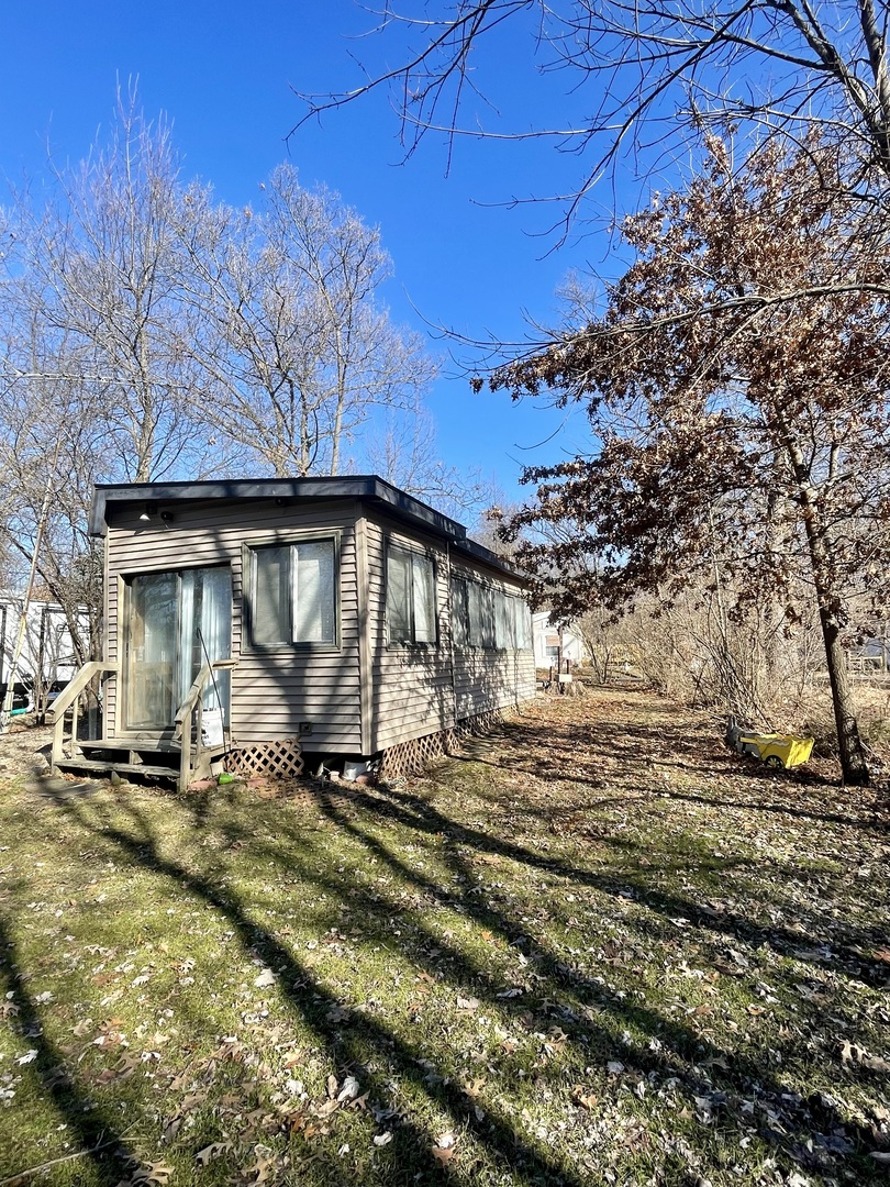 21-154 Woodhaven Lakes Sublette, IL 61367 - Photo 13 of 15 a view of a house with a big yard