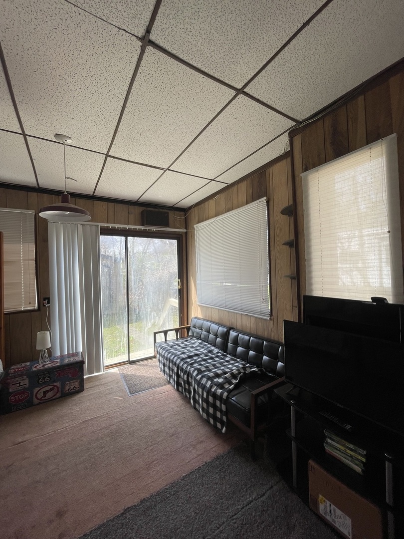 21-154 Woodhaven Lakes Sublette, IL 61367 - Photo 7 of 15 a room with lots of windows and flat screen tv