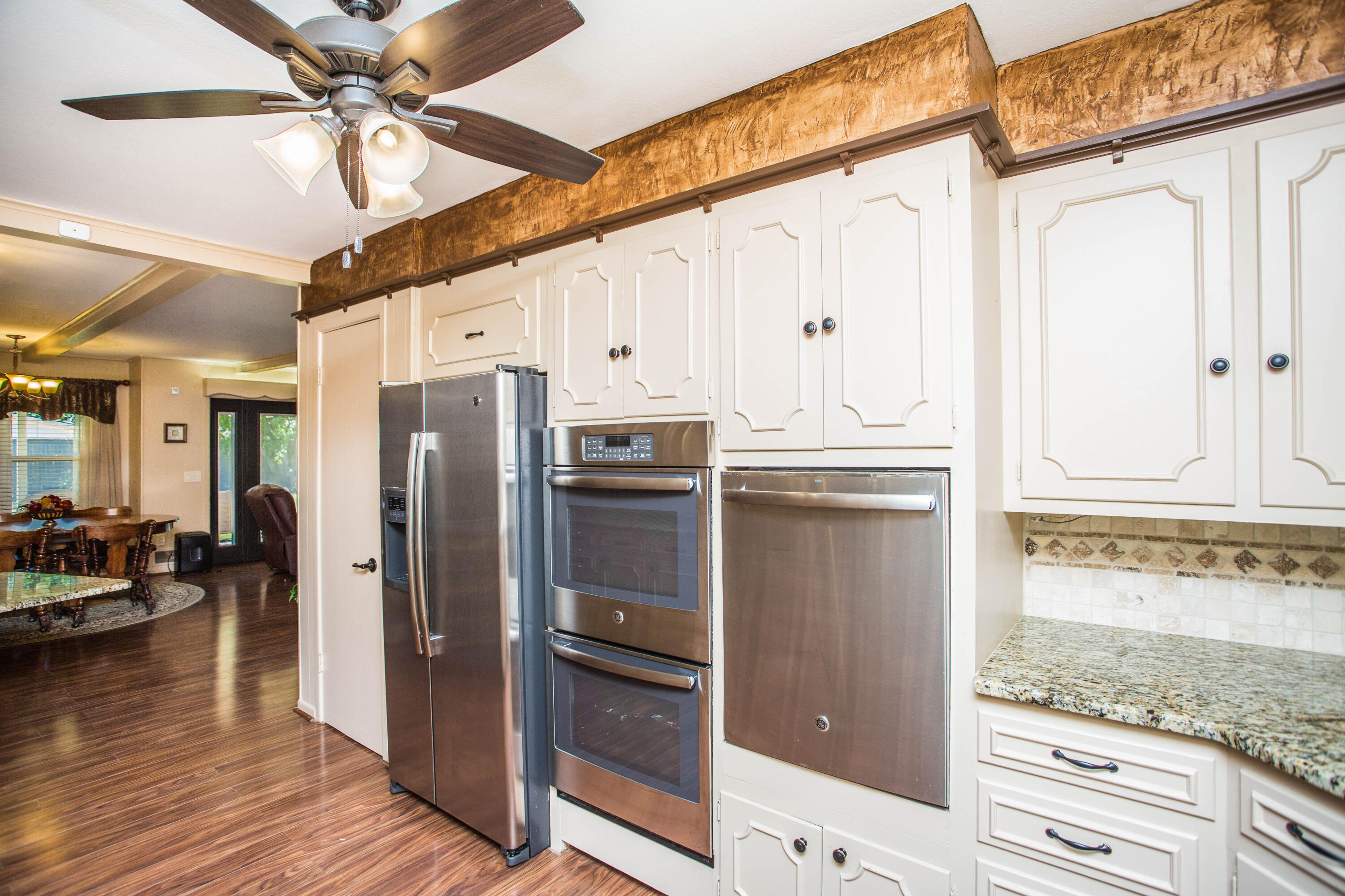 1208 Dallas Plainview, TX 79072 - Photo 9 of 24 a kitchen with stainless steel appliances granite countertop a refrigerator and a stove