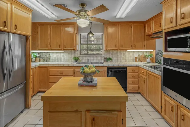 a kitchen with a sink appliances and cabinets