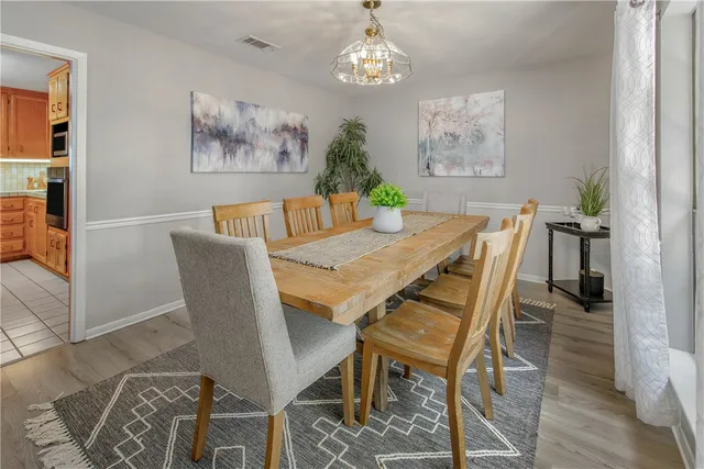 a bedroom with a bed mirror and a large window