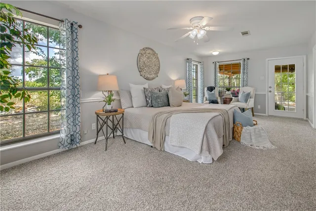 a bathroom with a tub shower and mirror
