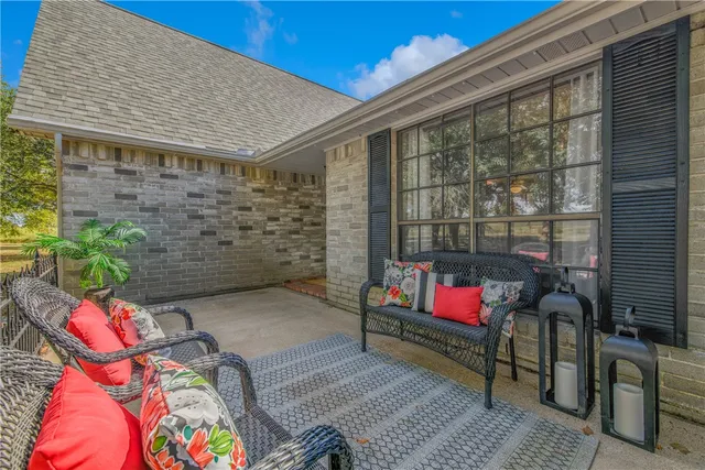 an outdoor space with patio couch and chairs