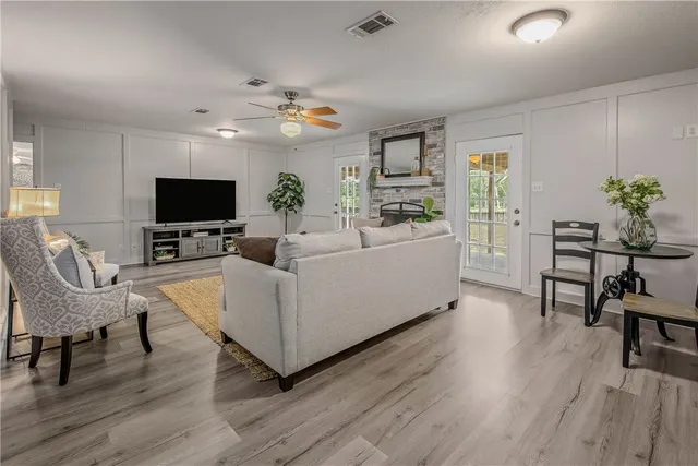 a living room with furniture and a flat screen tv
