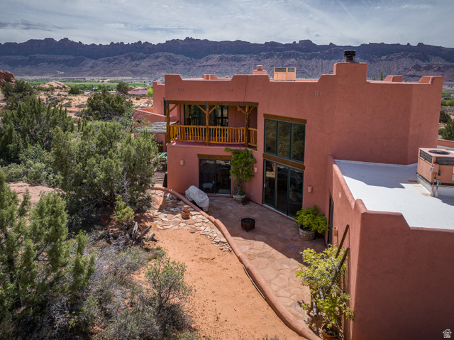 3617 Red Rock Drive Moab, UT 84532 - Photo 60 of 79 Back of house featuring a mountain view and stucco siding