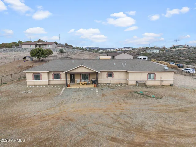 a view of a big house with a big yard and large trees