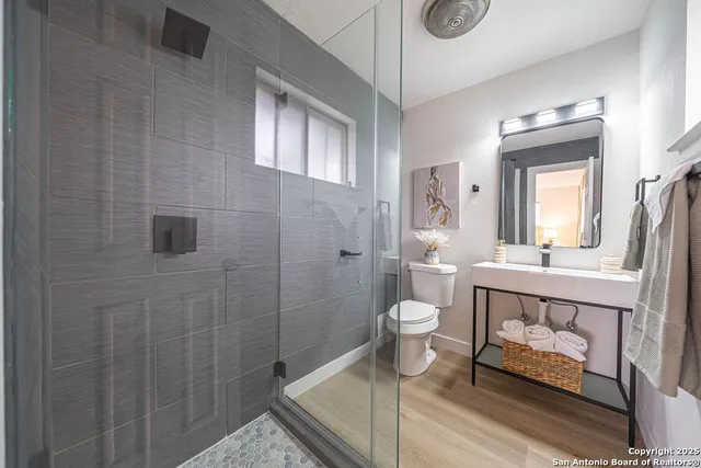 a bathroom with a toilet a sink and mirror