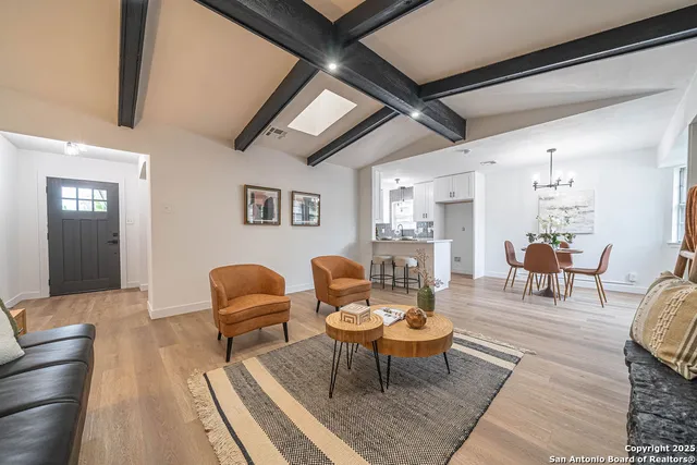 a living room with furniture wooden floor and a table